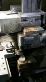 Turners and millers work at machines. The machines are turning out parts. Milling and lathe machines in a workshop in a factory. Vertical video.