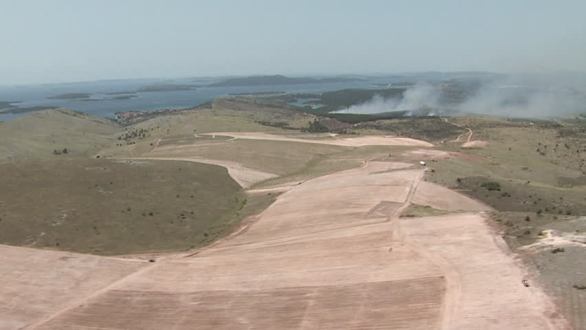 The fire and a yellow aircraft extinguishing it