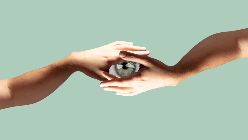 Stop motion, animation. Two hands holding eye pupil on pastel green background. Modern design, contemporary art. Inspiration, idea, trendy urban magazine style. Minimalism.