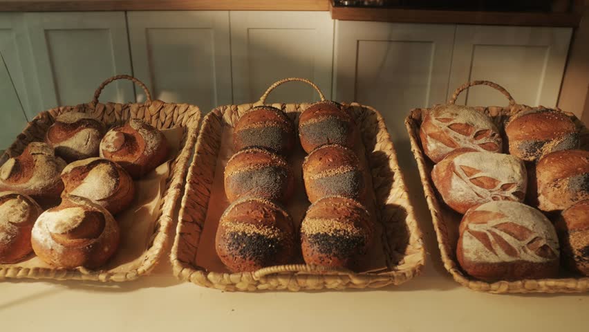 Fresh artesian bread on bakery shop close-up. Bread with black poppy garnish on top and white flour on top. Artisan bread is making by skill bakers using natural and high-quality ingredients. Food