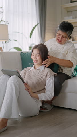 Beautiful family of mother and daughter together,hugging at home.happiness asian family candid of daughter hug mother senior elder mom cozy relax on sofa couch in living room.mother day,vertical video Royalty-Free Stock Footage #3459064929