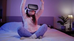 Little girl child wearing VR glasses studying science using virtual reality glasses at home, curious student wears virtual reality headset to study science at home online, explore futuristic lifestyle