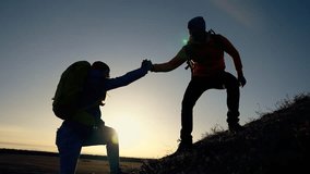 Successful business concept. man and woman together in mountains at sunset. teamwork. business and achieving goal together. success and help in the team. helping hand to achieve goal. joint success - Powered by Shutterstock - Get 15% off with code: PIKWIZARD15