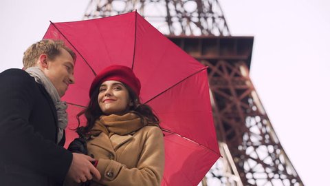 Beautiful girl looking forward to her boyfriend, rainy day, date in Paris