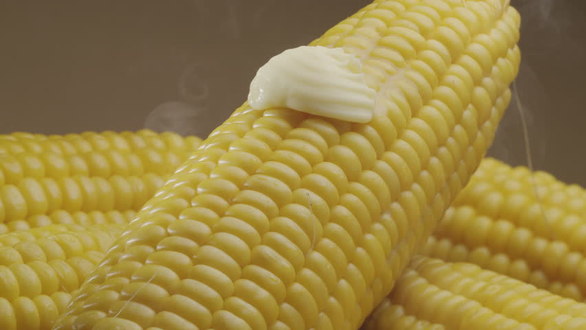 Piece of butter is slowly move along the ripe boiled cob of corn. Nice food background for your projects. Macro video shooting.  - Powered by Shutterstock - Get 15% off with code: PIKWIZARD15