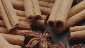 Lots of three spices for mulled wine – star anise, cinnamon and clove slowly scroll clockwise, macro video footage. Great background for your projects.