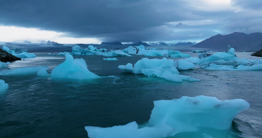 Flight Over Jökulsárlón Glacial Lake In Iceland At Sunrise - Drone Shot