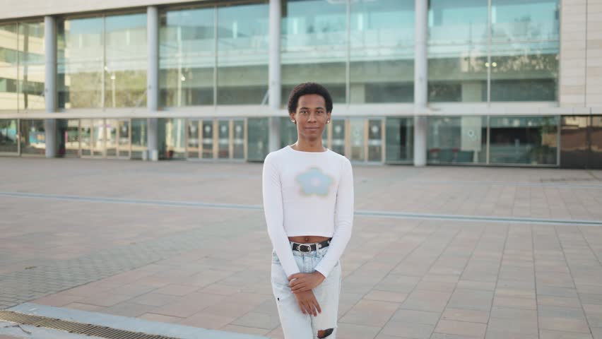 Portrait of a beautiful person smiling at the camera in city.