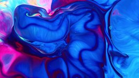 Close-up shot of multi-colored paint mixture boiling in a mixer. They form a unique abstraction that can be used in many video projects, as a background or as a compositing element.