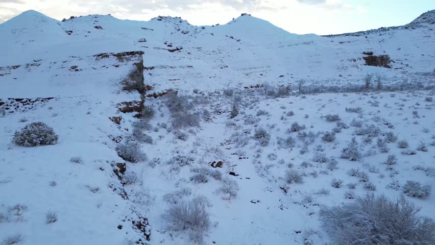 Colorado Blue Hour Snow Fly Forward Through High Desert Wilderness Grand Junction Snowfall Winter Wonderland Cold Early Morning Aerial Drone View Landscape Wallpaper Background Rock Formation Nature