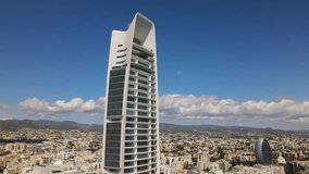 Aerial view of the cityscape of Limassol, Cyprus. The Oval building is an office building in the business center of the city. High quality 4K footage
