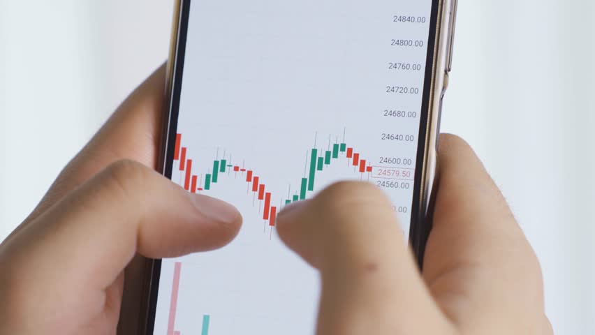 Online Trading Analysis, Cryptocurrency Market Insights , Delve into online trading analysis as a man examines cryptocurrency exchange charts on his smartphone, gaining valuable insights into Royalty-Free Stock Footage #3459421447