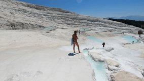 Tourist contemplating the turquoise water in Pamukkale thermal pools