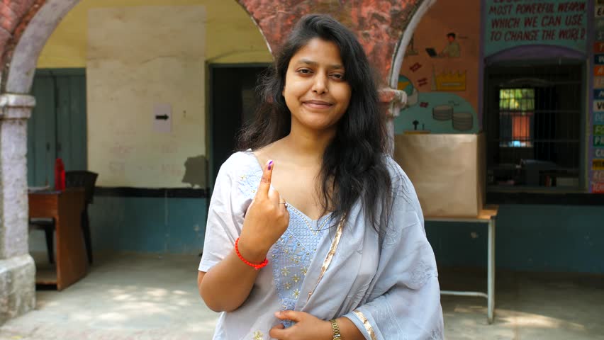 Female Indian voter showing the ink sign on her index finger after casting her vote - assembly election, state election. Responsible adult female encouraging people to vote during the elections - c... Royalty-Free Stock Footage #3459693953