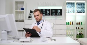 Medical Doctor Man Take Notes on Clipboard Handwriting Checklist Report Hospital