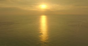 golden sky in sunset above the sea..aerial view golden sky in sunset above the sea video 4K. Nature video High quality footage. .Scene of Colorful romantic sky sunset with orange color of the sky 