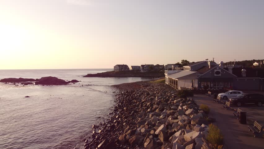 Aerial sunset of Ogunquit Maine USA Atlantic Ocean coastline with waterfront beach house hotel resort 