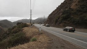 Malibu Canyon Road in Malibu, California with vehicles driving and stable video. - Powered by Shutterstock - Get 15% off with code: PIKWIZARD15
