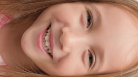 Little girl rejoices and smiles, close-up portrait. Vertical video. - Powered by Shutterstock - Get 15% off with code: PIKWIZARD15