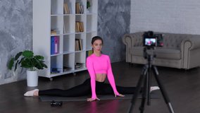 Fitness trainer instructor doing yoga exercise, sitting on floor and stretching