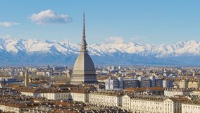 Turin, Italy. View of the Mole Antonelliana from above. Cityscape with Piazza Vittorio Veneto with the snow-capped Alps in the background. Timelapse pan zoom in video. 2024-03-12.