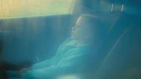Pensive child waits for parents in car on rainy day. Depressed little girl sits along in auto under heavy rain storm. Abused kid in automobile at storm - Powered by Shutterstock - Get 15% off with code: PIKWIZARD15