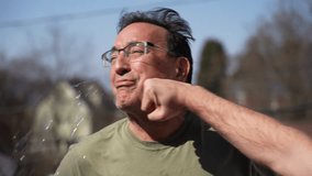 A funny slow motion view of a man getting punched in the face while spitting out water.  	 - Powered by Shutterstock - Get 15% off with code: PIKWIZARD15