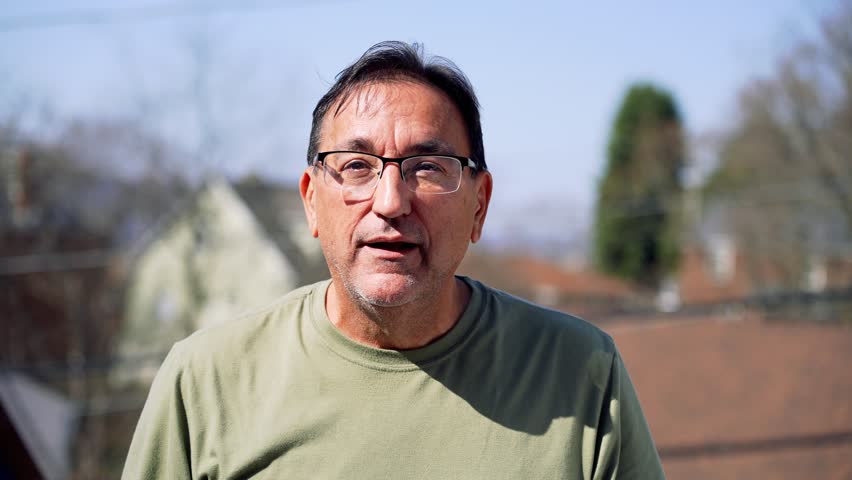 A slow motion view of a surprised man slapping himself in the face.  	