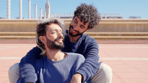 Closeup of romantic couple enjoying together outdoors. Two men embracing in a touristic destination Video Stok