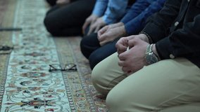 A man prays with a rosary during prayer in a mosque
