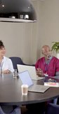 Vertical video of diverse doctors in meeting with copy space, slow motion. Medicine, healthcare services, work, office, professionals concept, unaltered.