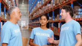 Animation of network of connections with icons over diverse volunteer high fiving in warehouse. Global shipping, connections, computing and data processing concept digitally generated video. - Powered by Shutterstock - Get 15% off with code: PIKWIZARD15