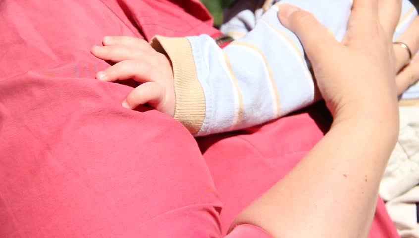 Baby's hand with mom
 | Shutterstock HD Video #34602025