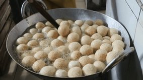 Video of a food seller busy frying onde-onde, a very popular snack in Indonesia