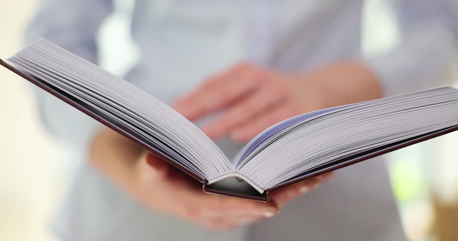 Lady flips through paper book reading useful information for self-development. Assimilation of information in adulthood. Development and erudition via education Royalty-Free Stock Footage #3460233627