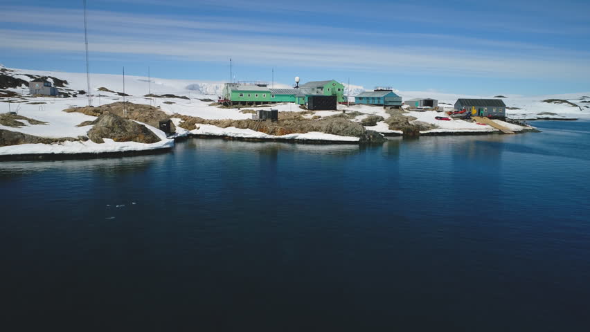 Blue water near Polar Antarctic Vernadsky Base Aerial view. Ocean Coast Open Water Surface Wild Nature. South Pole Station Mountain Landscape Drone Flight Footage Shot
