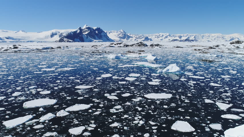 Floating Ice and Iceberg Aerial View. Antarctica Blue Color Ocean Turquoise Water. Global Warming Landscape. Polar Nature Climate Change Drone Flight View Footage