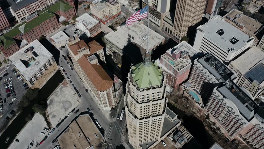 Overhead drone shot of the American flag atop of the Tower Life Building in San Antonio, Texas.