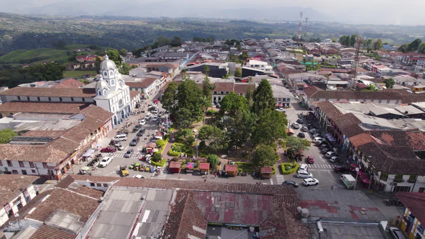Rush hour around Park in remote village Filandia in Colombia, aerial orbit