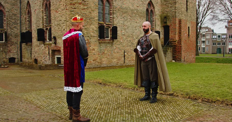 Fantasy scene: Knight kneeling down in front of king and being knighted in front of castle