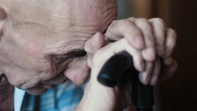 portrait of an elderly man in thought. A 70-year-old Caucasian pensioner, sitting with a walking cane, bowed his head thoughtfully. thoughts about life - Powered by Shutterstock - Get 15% off with code: PIKWIZARD15