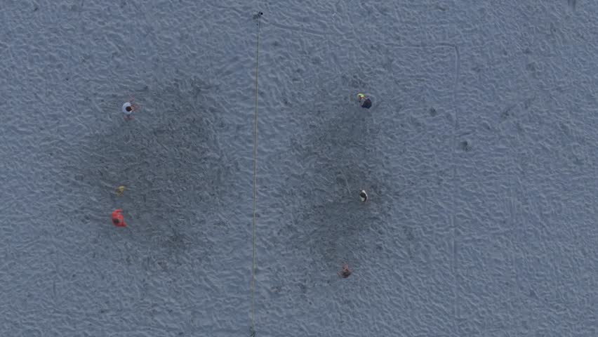 Aerial view of people playing volleyball on the beach during sunset, Friesland, Netherlands