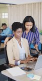Vertical video of african american business people using laptop with copy space, slow motion. Working at office, business concept.