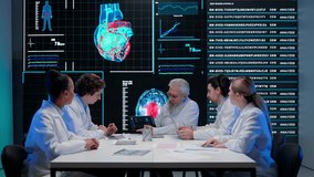 Pharmaceutical research company planning. Multiethnic doctors and scientists having meeting with heart diagnosis data visual graphic on big digital screen. - Powered by Shutterstock - Get 15% off with code: PIKWIZARD15