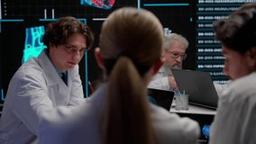 Pharmaceutical research company planning. Multiethnic doctors and scientists having meeting discussing diagnosis data visual graphic on big digital screen. - Powered by Shutterstock - Get 15% off with code: PIKWIZARD15