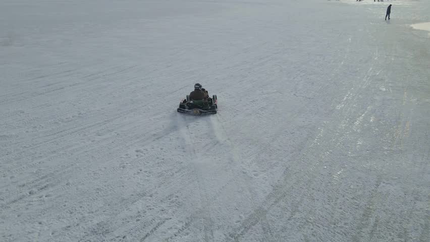 Aerial view of ice karting on frozen lake at day time, IJsselmeer, Netherlands