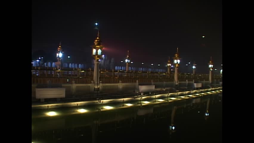 INDIA - 1999 - Pan towards India's Golden Temple and its surrounding sacred pool at night. Royalty-Free Stock Footage #3460594863