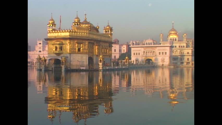 INDIA - 1999 - India's Golden Temple is reflected in the sacred pool it stands above. Royalty-Free Stock Footage #3460597447