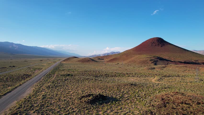 CALIFORNIA - 2.22.2024 - Excellent aerial footage moving along the highway towards a volcanic formation in California