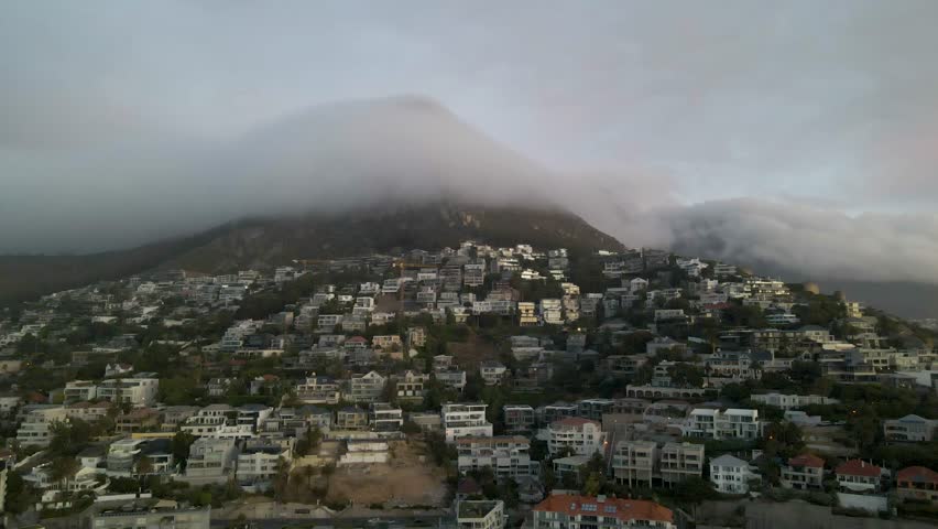 View of morning fog under Table Mountain at sunrise, Cape Town, South Africa.